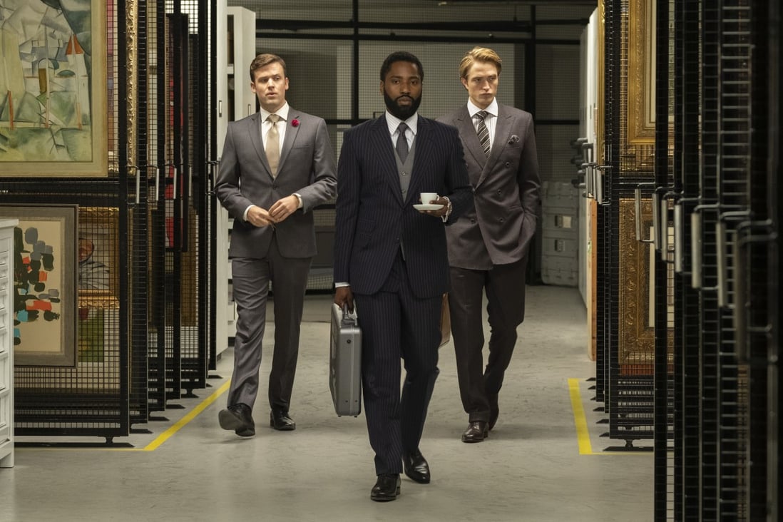 John David Washington (centre) and Robert Pattinson (right) in a still from Tenet, which wrapped shooting last year before the coronavirus outbreak.