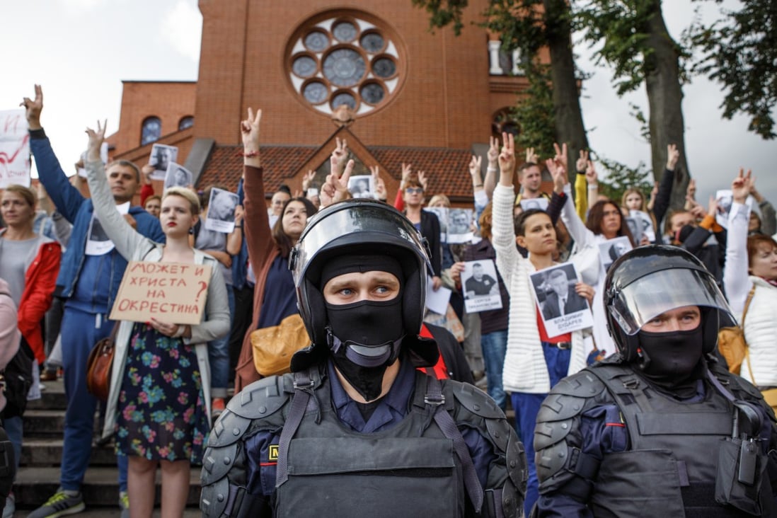 Riot police block protesters in front of a church in Minsk, Belarus on Thursday. Photo: AP