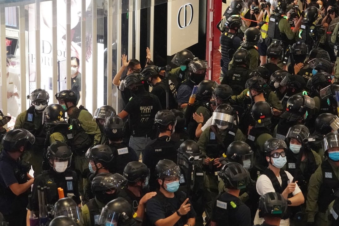 Riot police officers arrest an anti-government protester during a demonstration to mark the first anniversary of the Yuen Long attacks, at Yoho Mall on July 21. Photo: Felix Wong