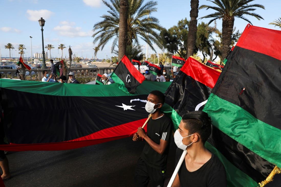 Demonstrators march during an anti-government protest in Tripoli, Libya. Photo: Reuters