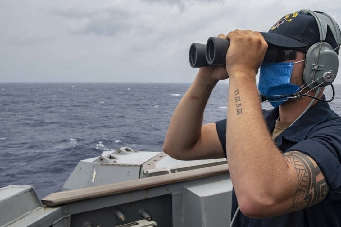 A crew member on the guided-missile destroyer USS Mustin keeps watch during a freedom of navigation operation near the Paracel Islands in the South China Sea on August 28. Photo: US Pacific Fleet