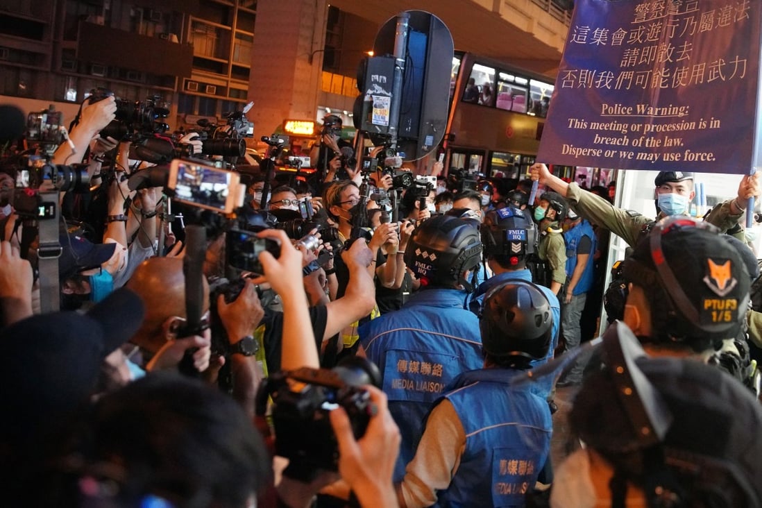 Police raise a blue flag warning demonstrators they may be taking part in an illegal assembly. Photo: Winson Wong