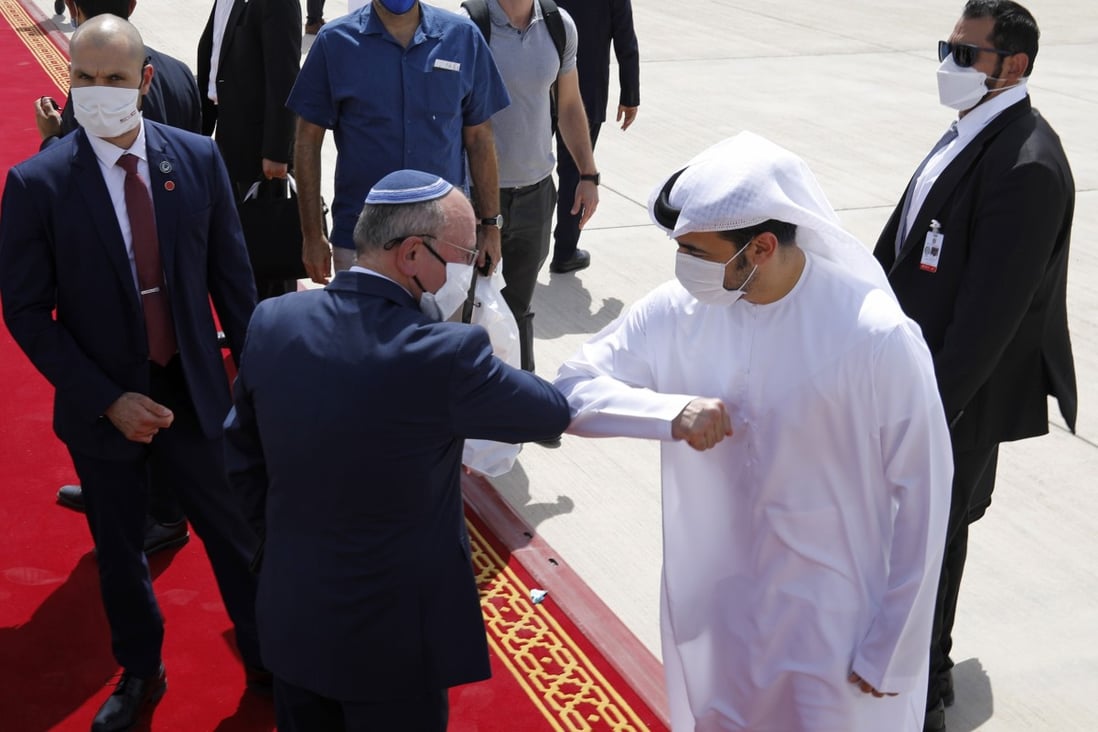 Israeli National Security Advisor Meir Ben-Shabbat elbow bumps with an Emirati official as he makes his way to board the plane to leave Abu Dhabi. Photo: EPA-EFE