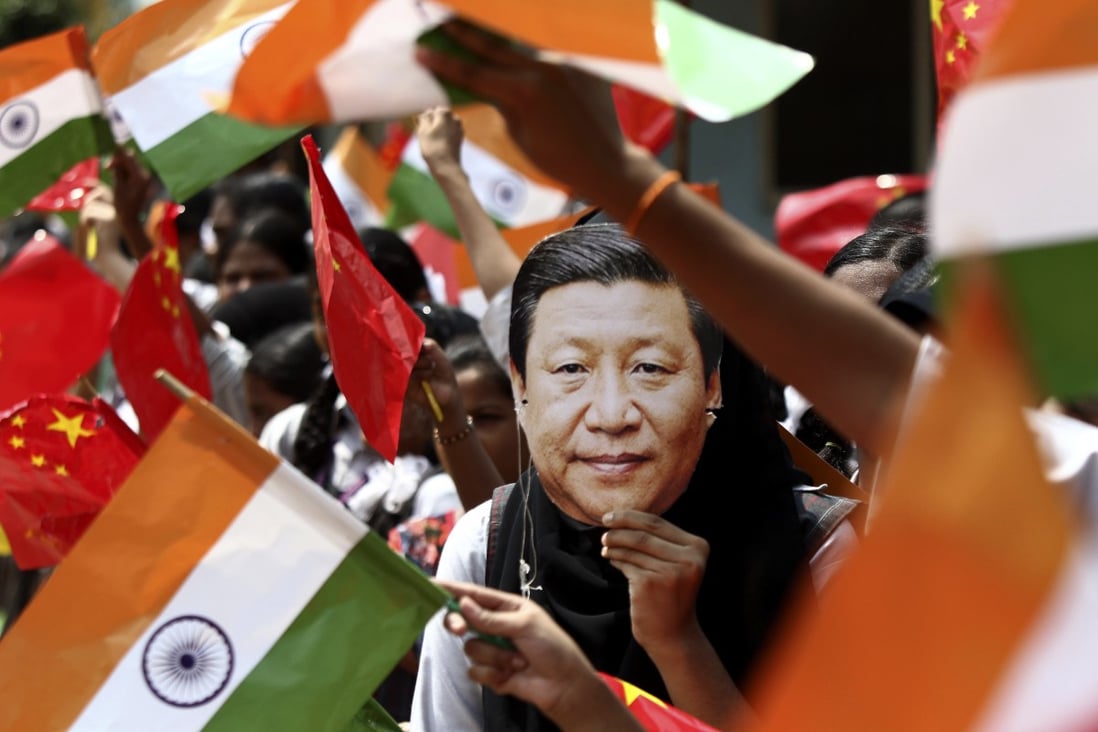An Indian schoolgirl wears a mask depicting Chinese President Xi Jinping during his visit to Chennai in 2019. Photo: AP