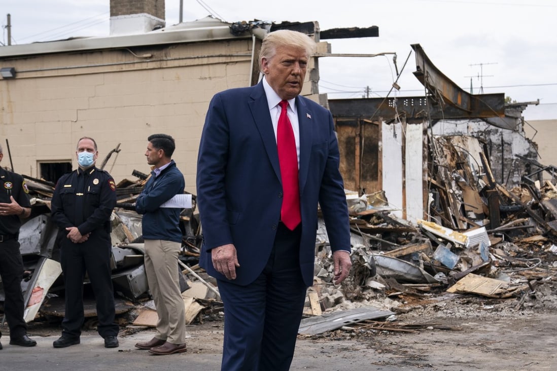President Donald Trump tours an area damaged during demonstrations in Kenosha, Wisconsin. Photo: AP