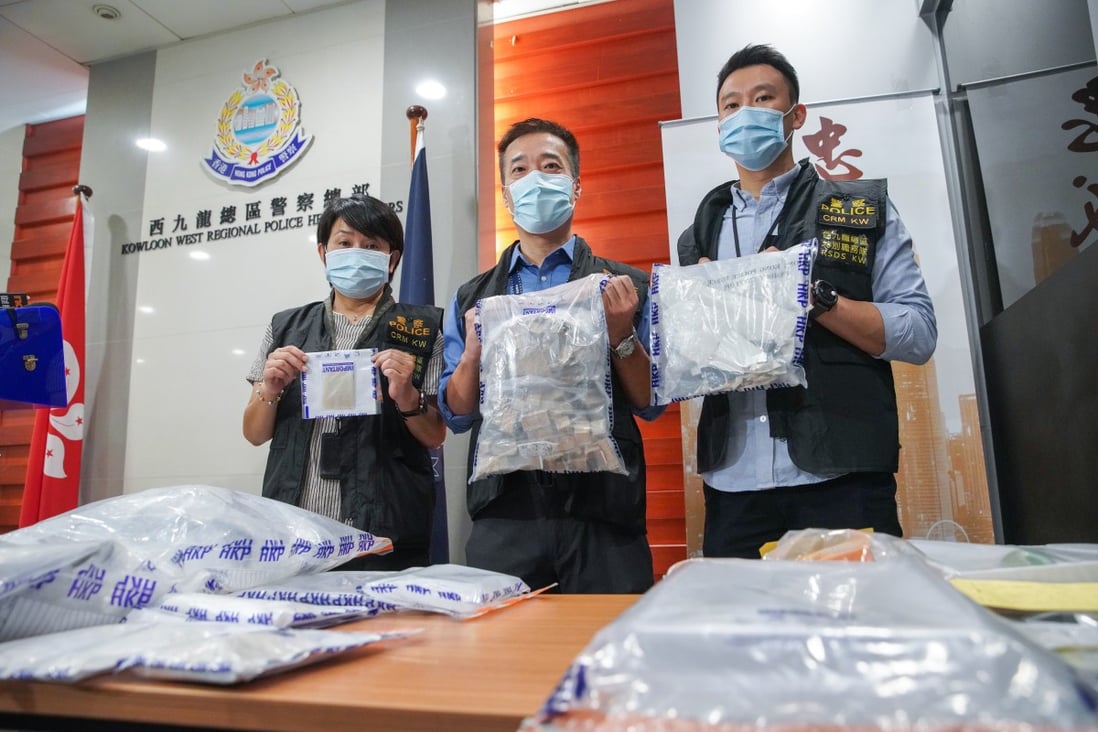 Officers (from left) Lam Yuen-ling, Alan Chung, and Chan Yuen-fun, with some of the evidence seized during the operation in Tsuen Wan. Photo: Winson Wong