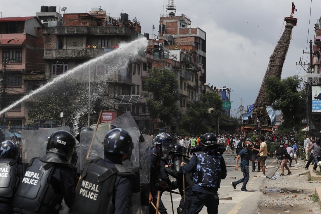 Nepal police clash with devotees defying virus ban for religious
