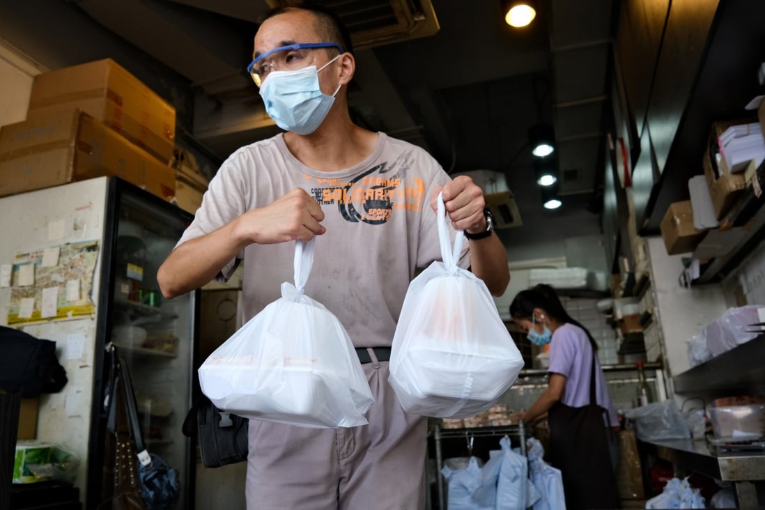 How Covid-19 adds to plastic waste: a man carries takeaway meals packed in single-use boxes carried in single-use plastic bags while wearing a single-use face mask in Hong Kong. Photo: AFP