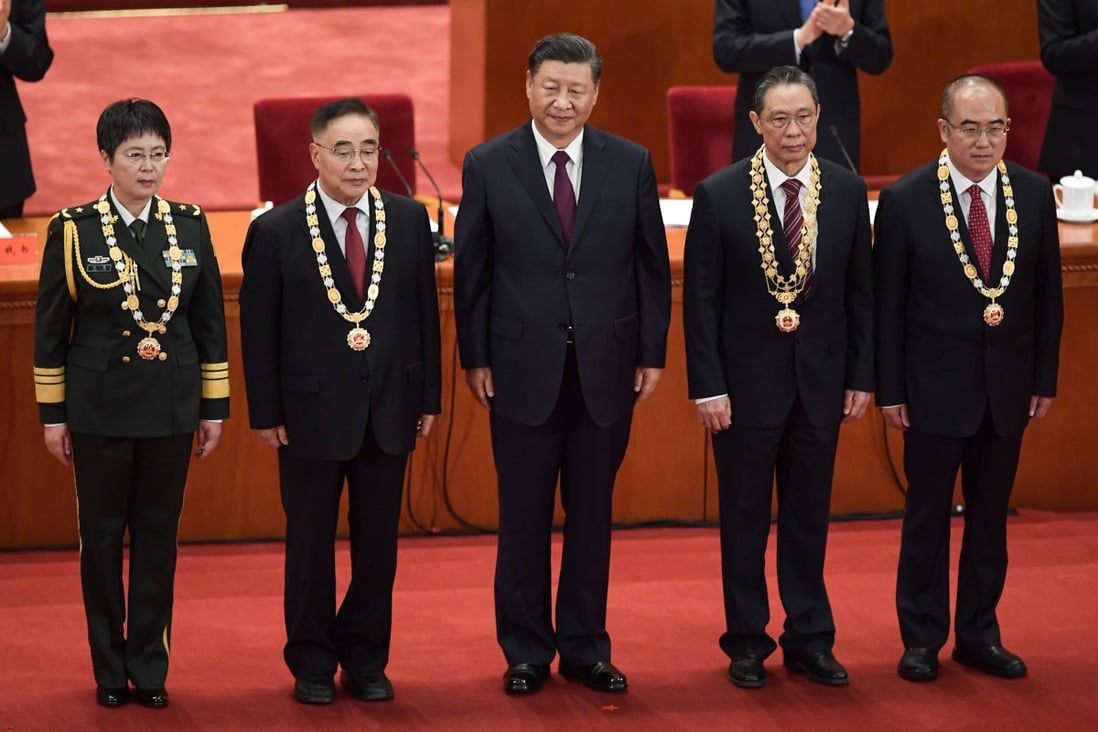 (From left) Major General Chen Wei, Zhang Boli, President Xi Jinping, Zhong Nanshan and Zhang Dingyu during the ceremony in Beijing on Tuesday. Photo: AFP