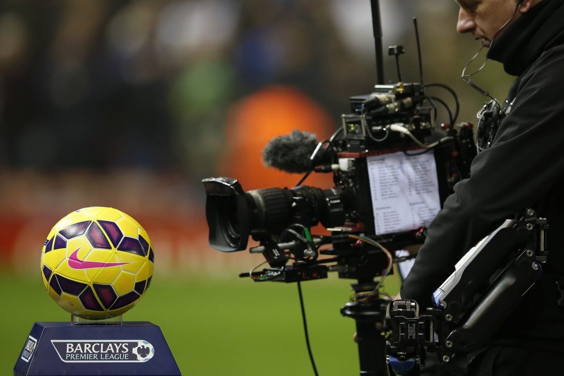 A television cameraman films the match ball before an English Premier League match. Photo: Reuters