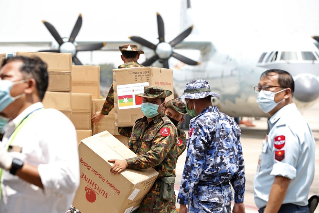 Myanmar soldiers carry medical aid provided by China at the Yangon International Airport. Photo: EPA