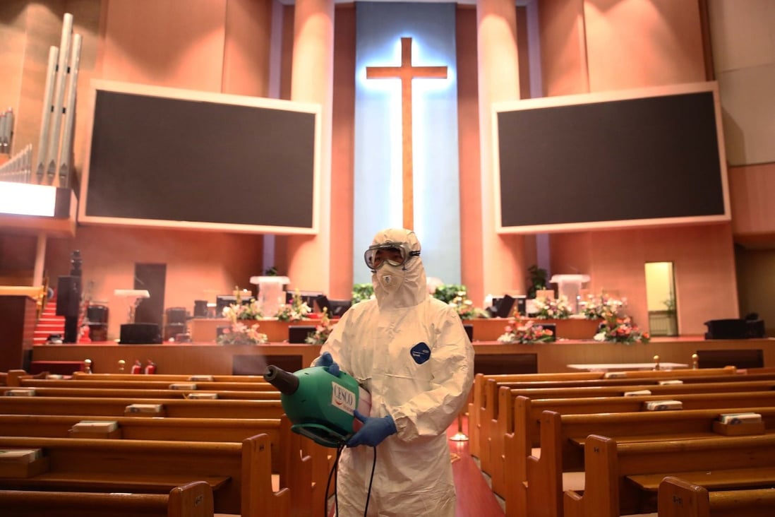 A health worker sprays anti-septic solution in a church in Seoul. Photo: Getty Images/TNS