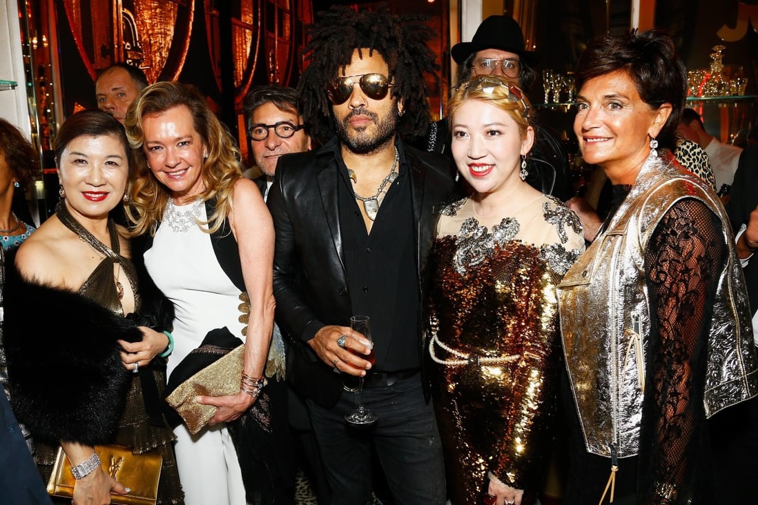 Rock star Lenny Kravitz to the right of Baccarat owner Coco Chu and its ex-CEO Daniela Riccardi at the Baccarat Goldfinger party in Paris on September 8, 2017. Photo: Getty Images