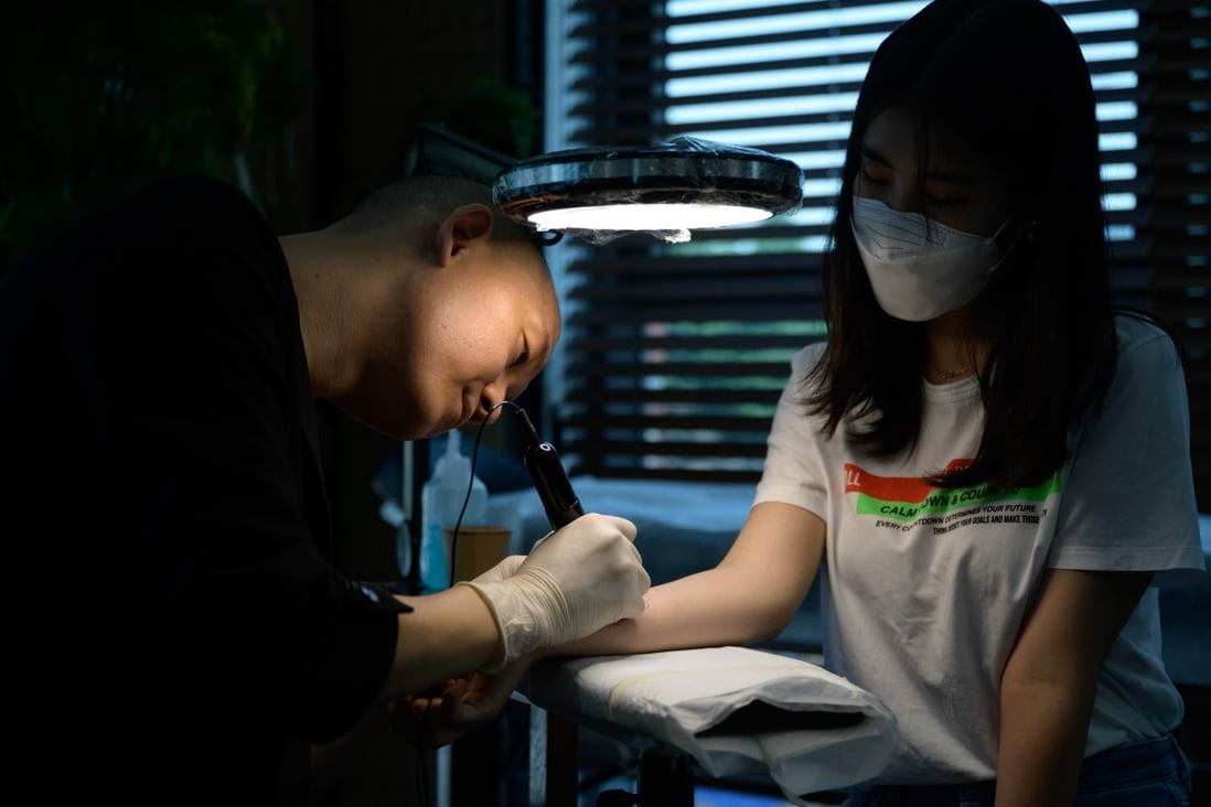Tattoo artist Doy, real name Kim Do-yoon, works on a client at his studio in Seoul. The South Korean tattooist, who counts Hollywood superstar Brad Pitt among his celebrity clients, is campaigning for the profession to be fully legalised in South Korea. Photo: AFP