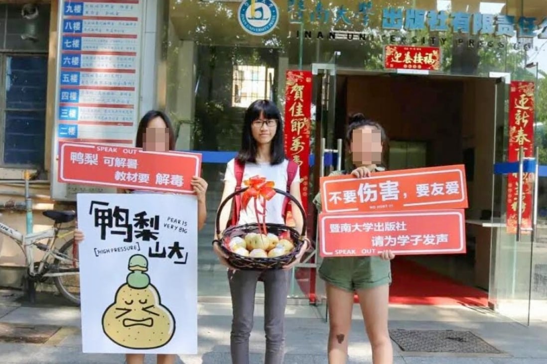 Xixi (centre) holds a basket of pears – in Chinese pear and pressure are homophones – as she raises awareness with friends outside the publisher’s office in Guangzhou. Photo: Handout