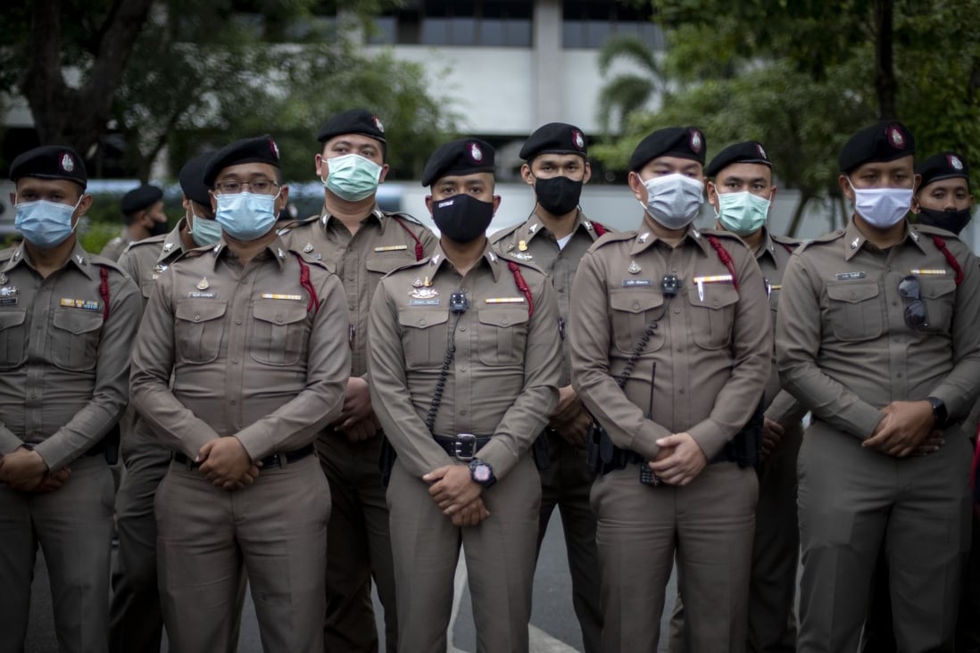 Police officers stand guard at the criminal courthouse in Bangkok. Photo: AP