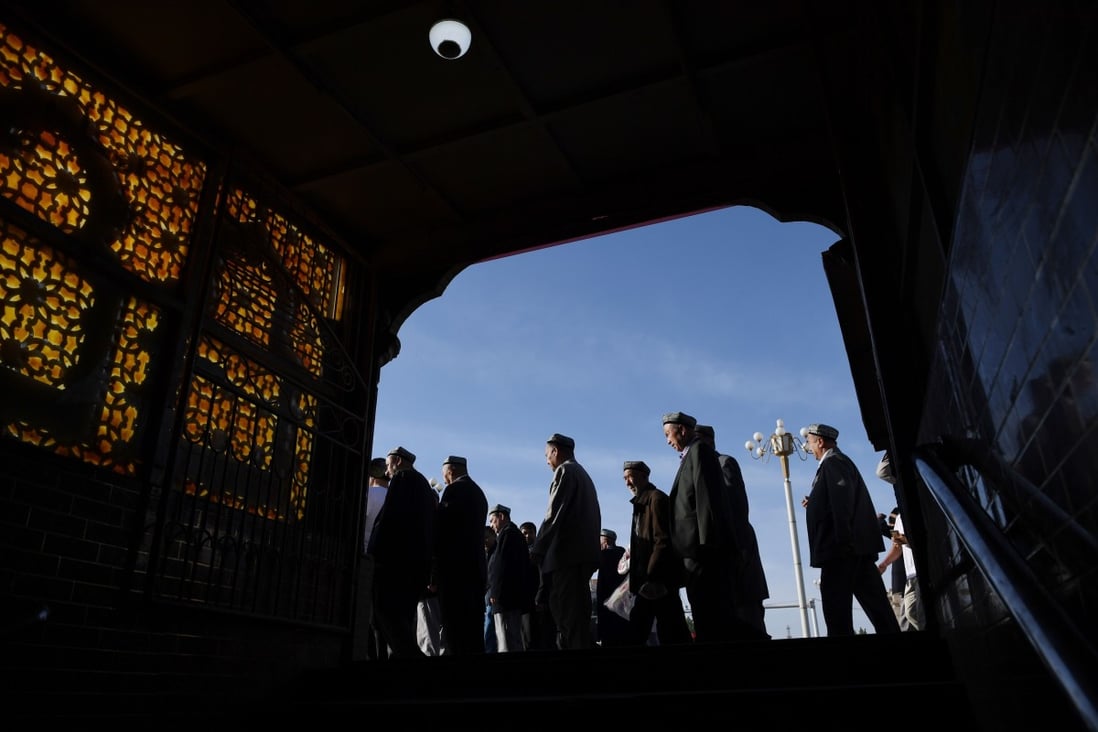 Uygur men make their way past a subway entrance after Eid al-Fitr prayers, marking the end of Ramadan, at the Id Kah mosque in Kashgar, in June last year. Photo: AFP