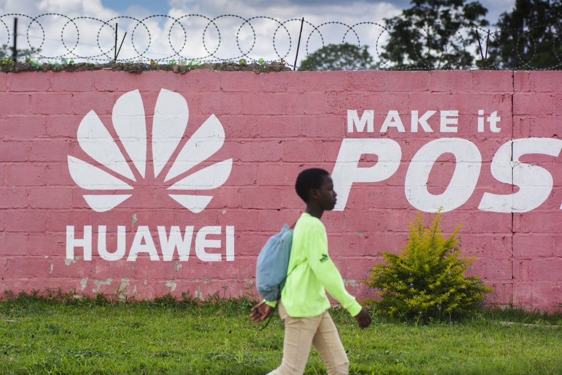 A pedestrian passes the Huawei logo painted on a wall in Lusaka, Zambia, on December 11, 2018. Many digital infrastructure projects in Zambia, like the more visible airport terminals and highways, are being built and financed by China. Photo: Bloomberg