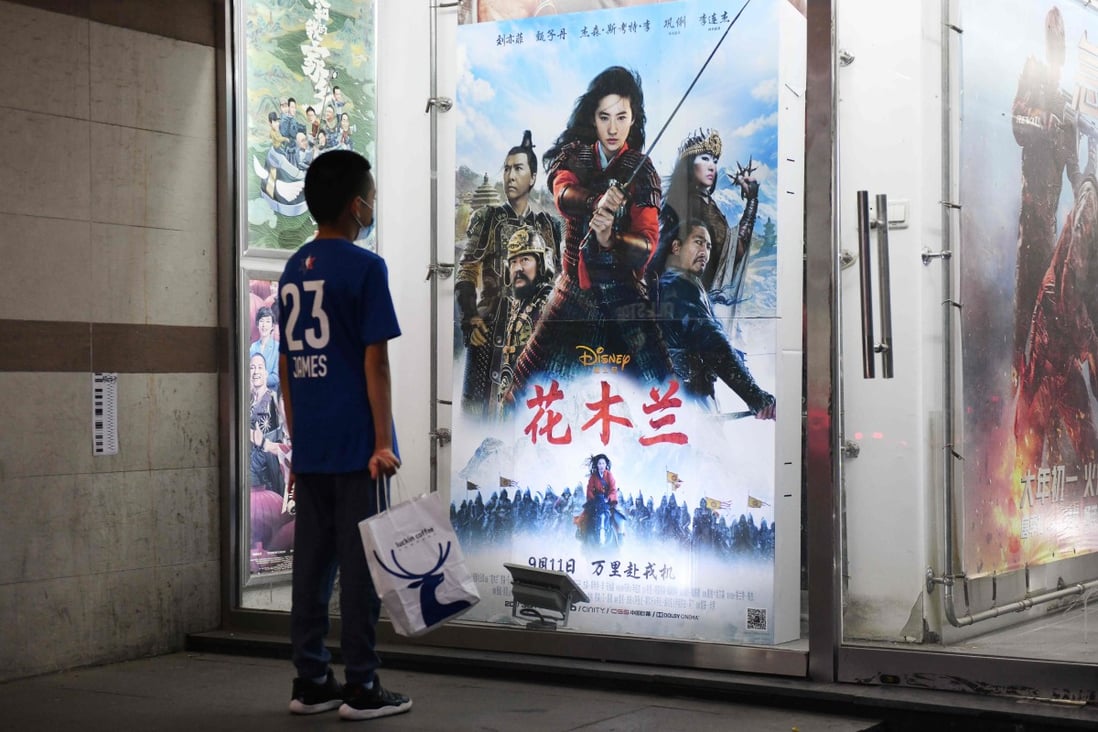 A boy looks at a poster promoting Disney movie Mulan outside a cinema on the day it opened in Beijing. The film has been pilloried internationally and given a lukewarm reception by Chinese cinema-goers. Photo: AFP