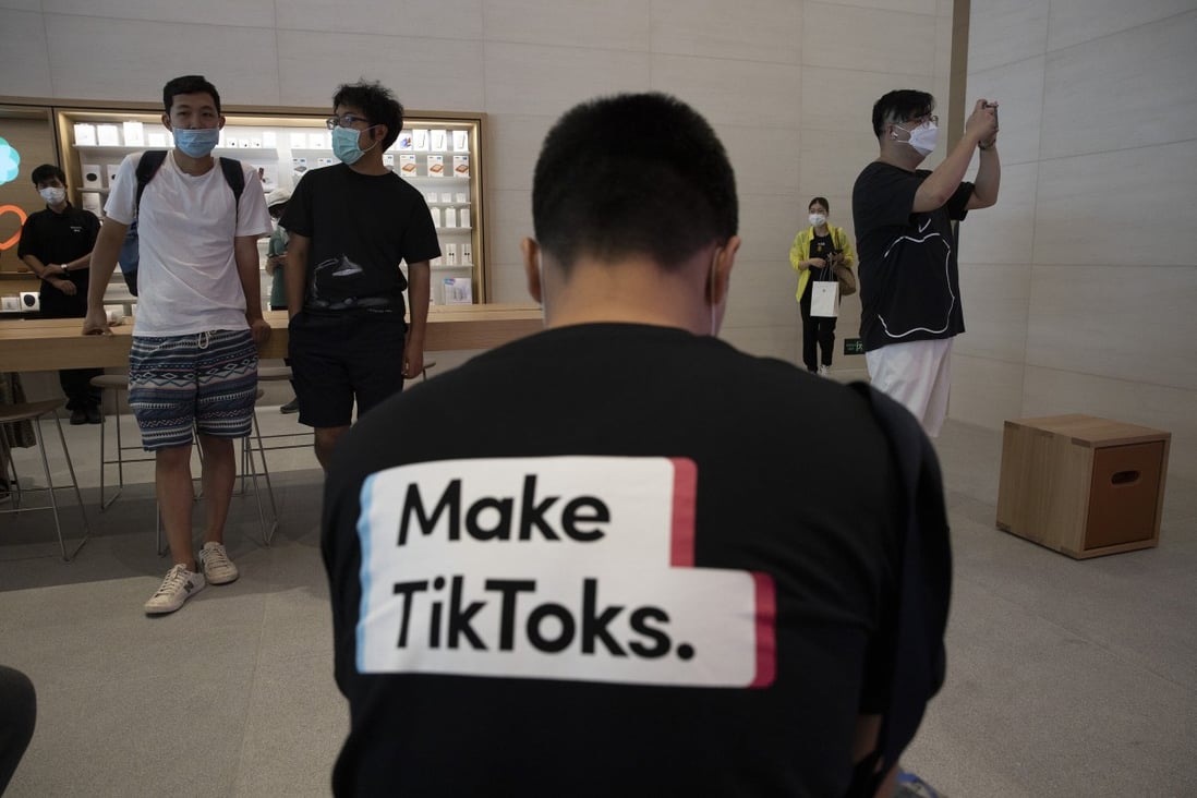 A man wearing a shirt promoting TikTok is seen at an Apple Store in Beijing on July 17. Photo: AP