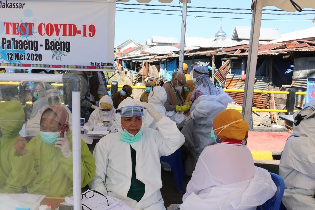 Health workers wear hazmat clothing while working on the front lines against Covid-19 in Indonesia. Patients worried about what neighbours will think have asked health workers to take them to hospital at dead of night. Photo: Shutterstock