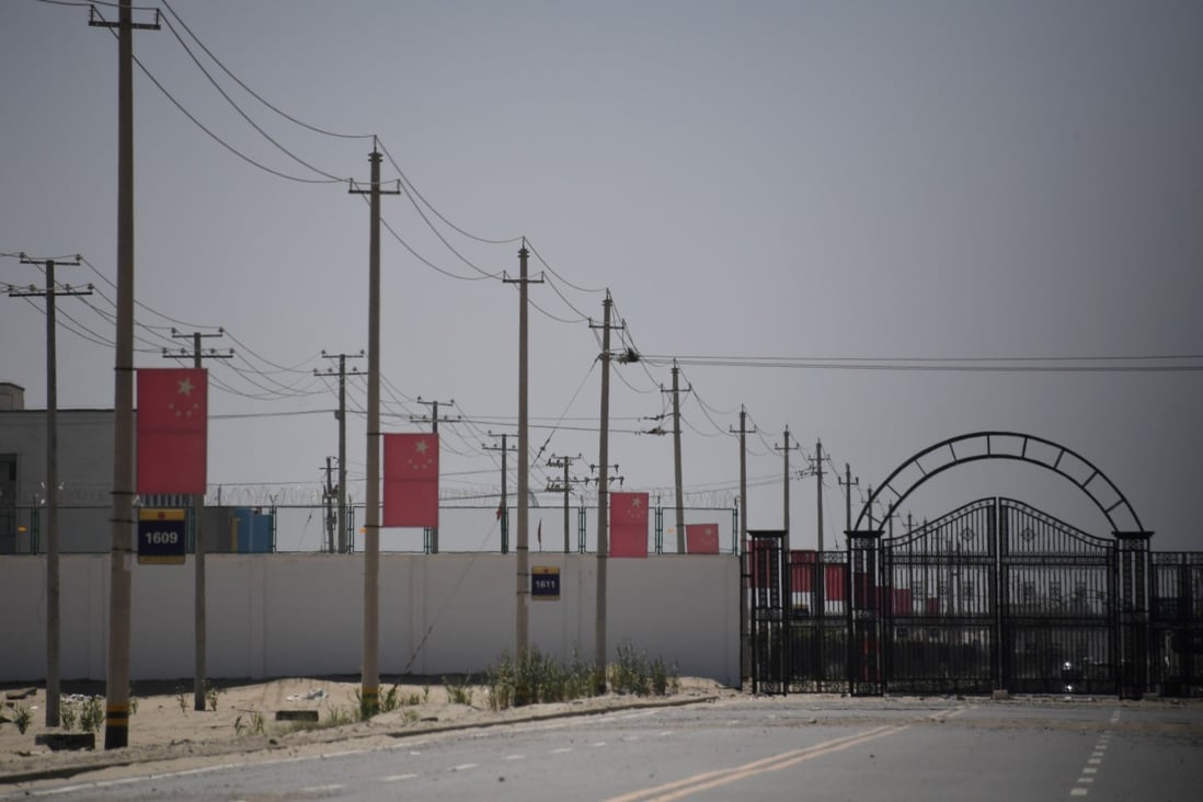 Chinese flags line a road leading to a facility believed to be a re-education camp where Muslim ethnic minorities are detained on the outskirts of Hotan in Xinjiang. Photo: AFP