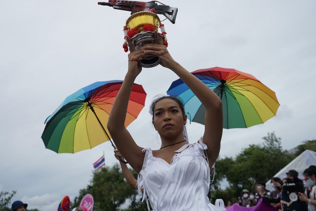 Angele Anang holds a bowl with a machine gun representing the military’s grip on power. Photo: Handout