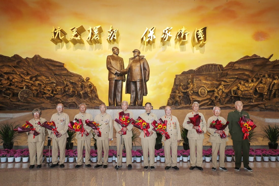 Veterans of the Chinese People's Volunteers (CPV) pose for a group photo at the Memorial Hall of the War to Resist US Aggression and Aid Korea in Dandong on Saturday, when it reopened. Photo: Xinhua