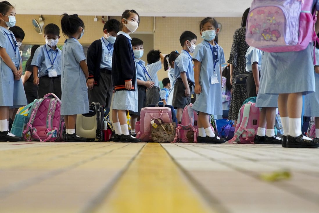 Children wait to have their temperatures checked at Yaumati Catholic Primary School (Hoi Wang Road). Photo: Winson Wong