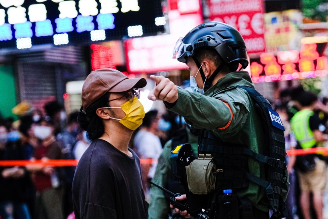 A police officer tells a man to move away during an anti-government protest in Hong Kong on September 6. Photo: dpa