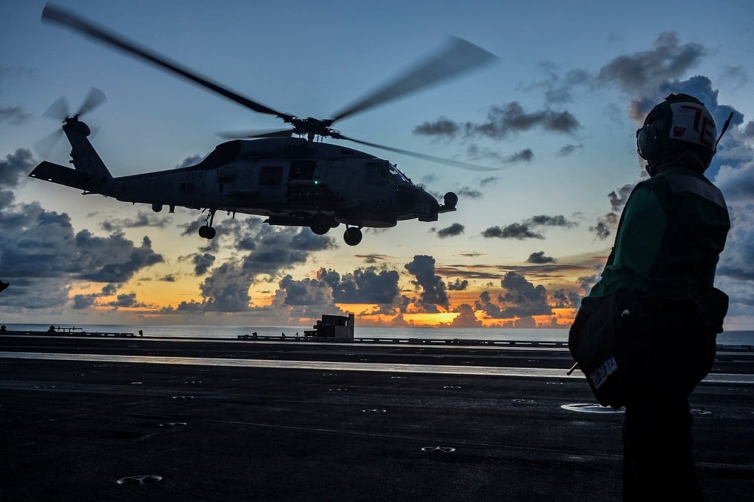 An MH-60R Sea Hawk helicopter launches off the USS Ronald Reagan in the South China Sea. Photo: Handout via Reuters