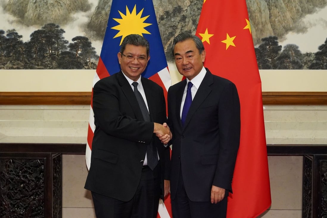 Chinese Foreign Minister Wang Yi (right) and former Malaysian foreign minister Saifuddin Abdullah agreed to South China Sea talks a year ago. Photo: Reuters