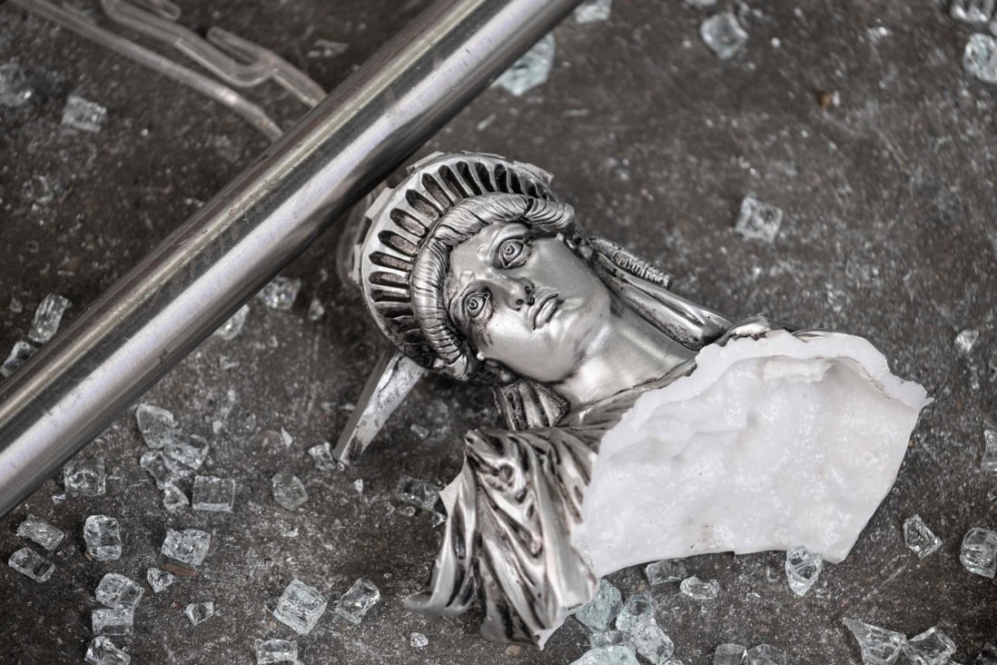 A broken Statue of Liberty figure is seen amid glass shards outside a looted souvenir shop in New York City, after a night of protests on June 2 over the death of George Floyd. Is the world seeing the end of the aura of American exceptionalism that has given the dollar Teflon-like resilience for most of the post-World War II era? Photo: AFP