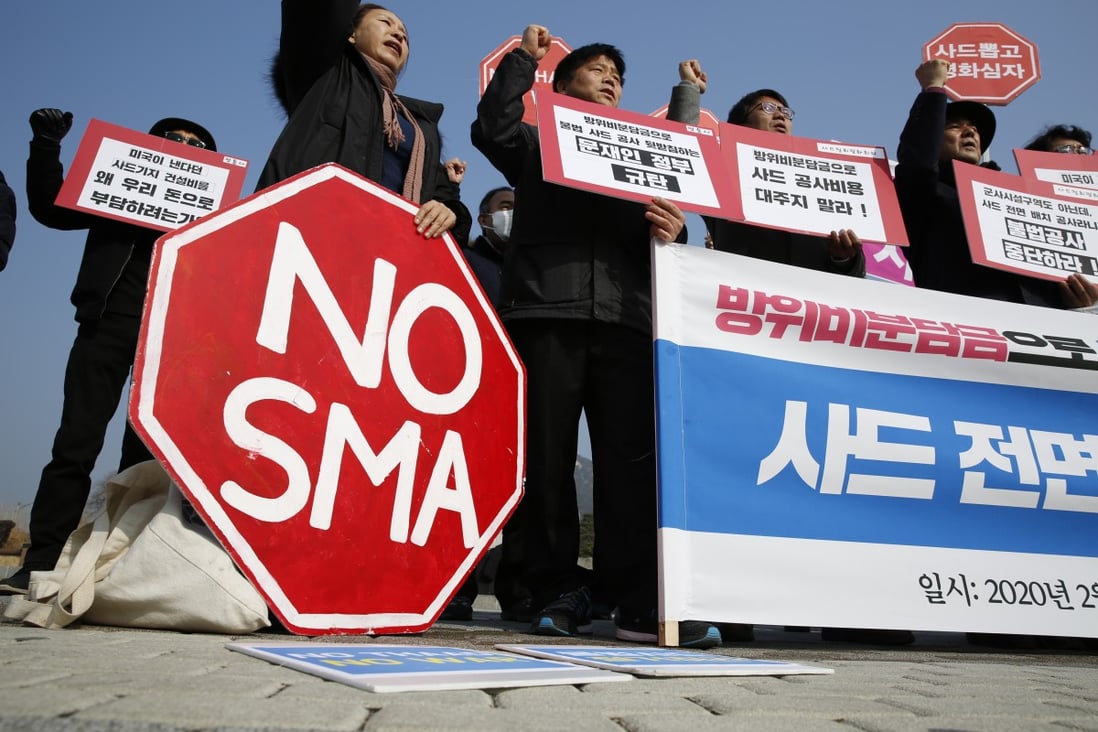 Residents near the base site of a US missile defence system, known as THAAD, shout slogans and hold placards at a rally to demand its removal. Photo: EPA