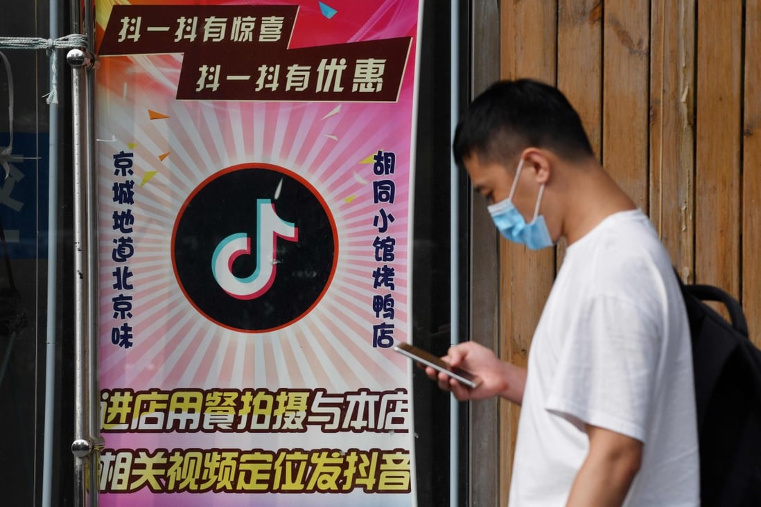 A man walks past a restaurant with the TikTok app logo displayed in the window in Beijing on September 14. A US court in Washington has granted temporary legal relief to TikTok against a Trump administration ban on the short video-sharing service. Photo: Agence France-Presse