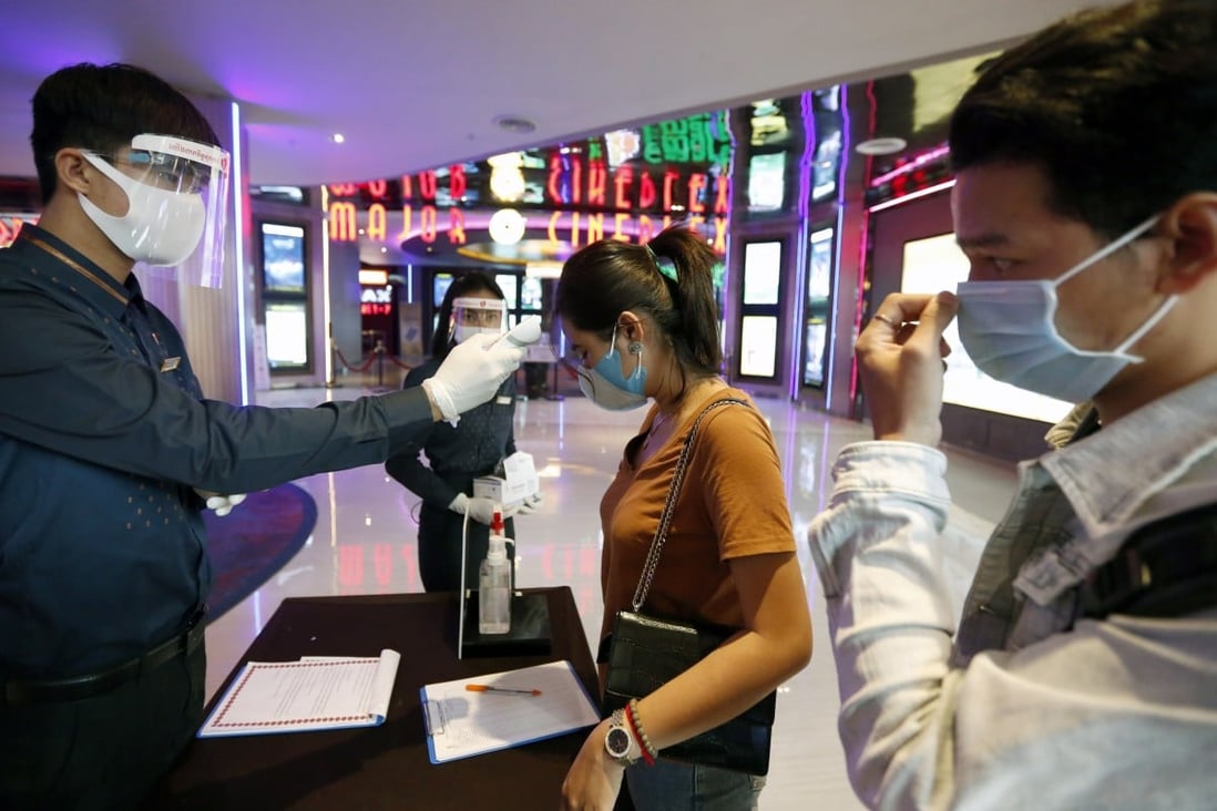 Cinema patrons get their body temperature checked as part of Covid-19 screening. Design changes to entertainment premises are needed in the long run to fight the virus. Photo: EPA-EFE