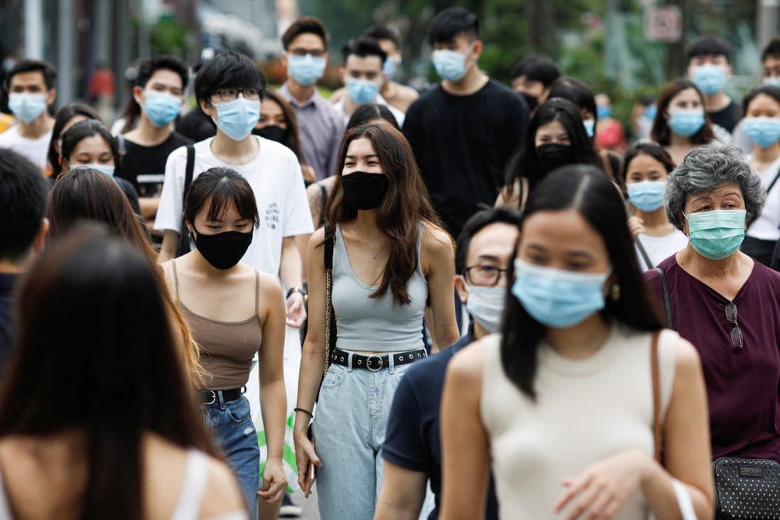 Shoppers in Singapore’s Orchard Road district wearing masks. Photo: Reuters