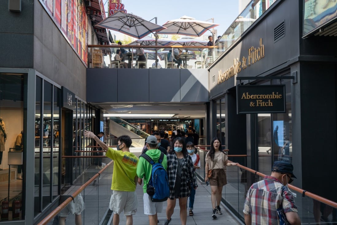 People wearing protective masks walk around a shopping area in Beijing in September 2020. China’s economic recovery from Covid-19 accelerated, spurred by a rebound in consumption. Photo: Bloomberg