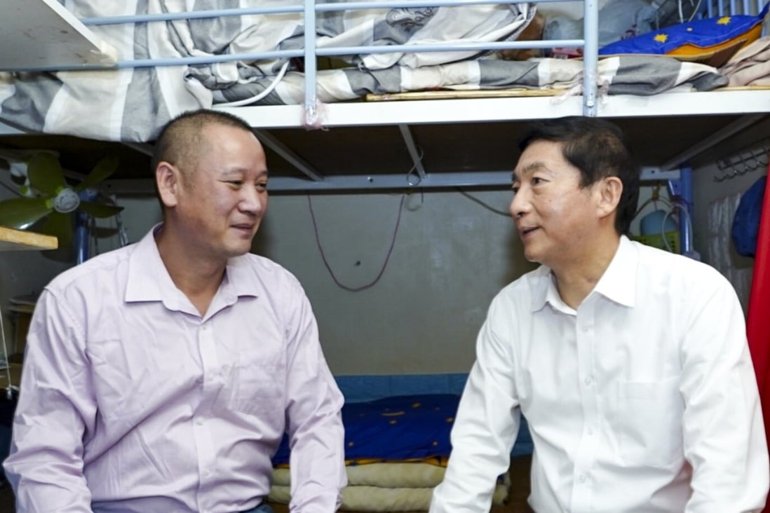 Luo Huining, director of Beijing’s liaison office in Hong Kong, talks with a man in his subdivided Sham Shui Po flat. Photo: Handout