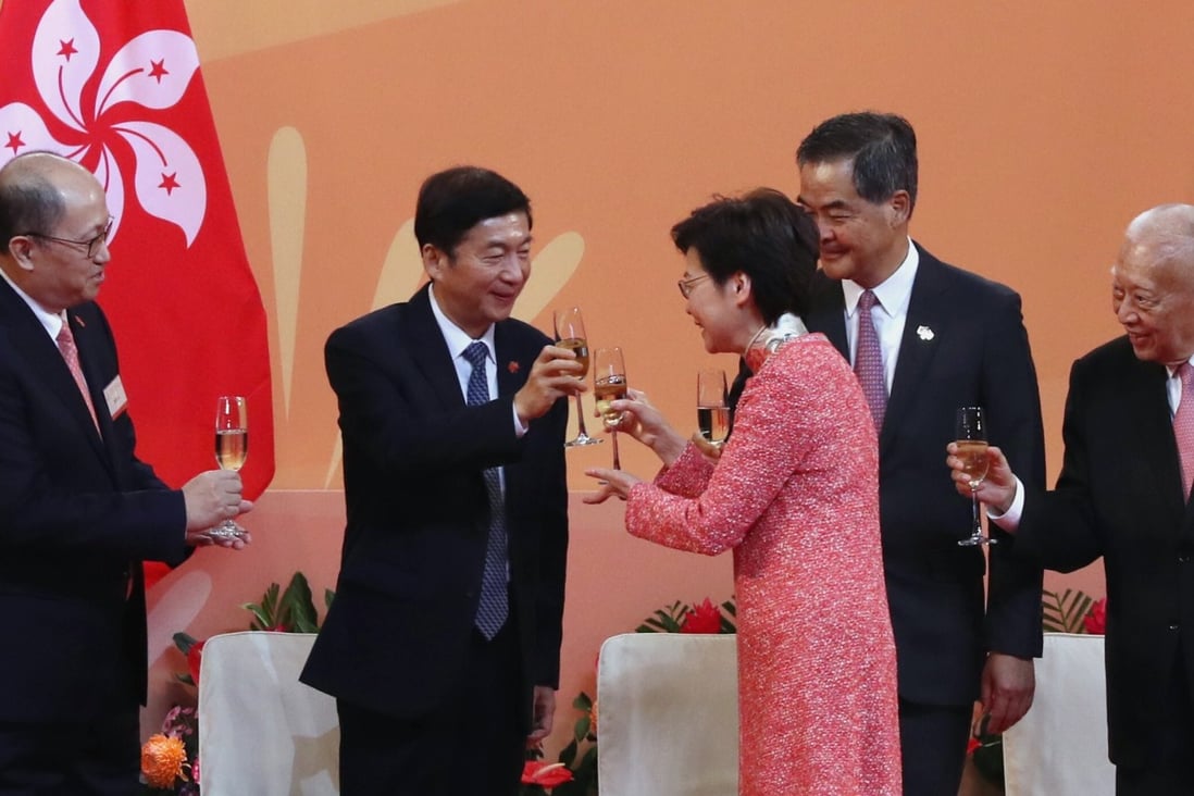 Carrie Lam raises a glass with Luo Huining, director of the central government's liaison office in Hong Kong, as other dignitaries look on. Photo: Nora Tam