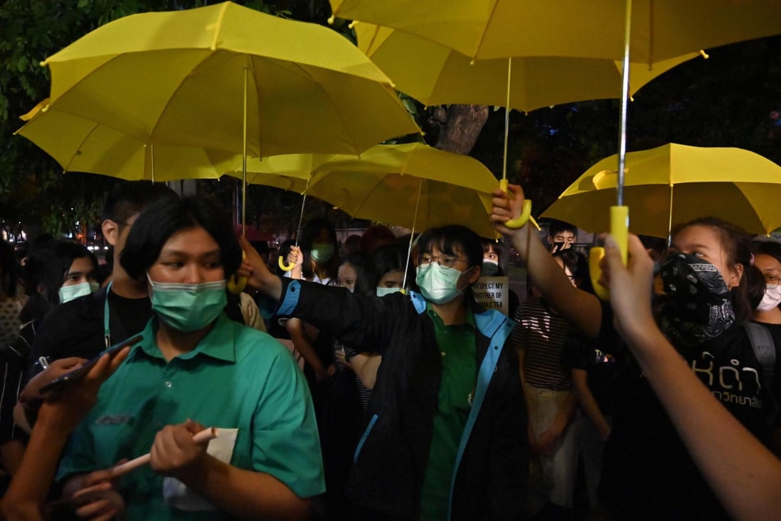 Students hold yellow umbrellas during an anti-China protest outside the Chinese embassy in Bangkok on October 1. Photo: AFP