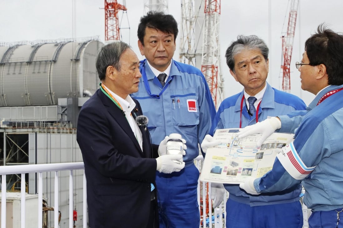 Yoshihide Suga, left, on his first official domestic visit to the disaster-stricken Fukushima Daiichi nuclear power plant last month. Photo: Kyodo