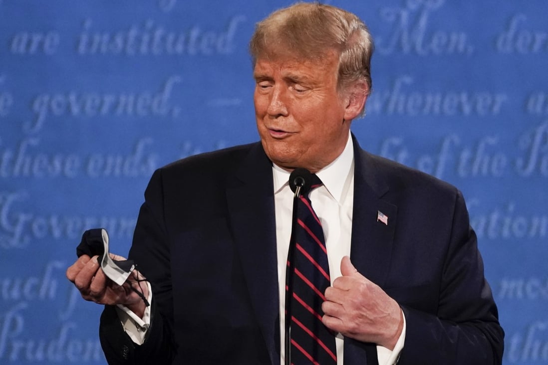 President Donald Trump holds a face mask during the first presidential debate on Tuesday in Cleveland, Ohio. Photo: AP