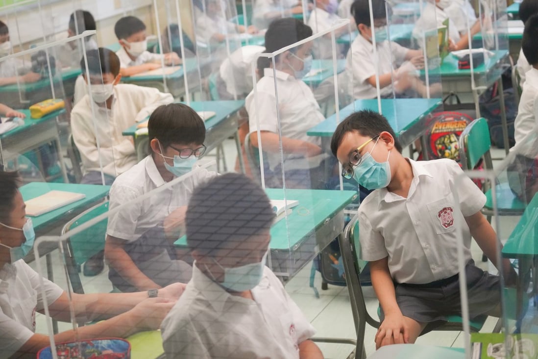 Students return to in-person classes at a primary school in Cheung Sha Wan on September 29. Nearly 900,000 pupils from all Hong Kong schools and kindergartens have returned to in-person classes for the first time in more than half a year amid the Covid-19 pandemic. Photo: Winson Wong