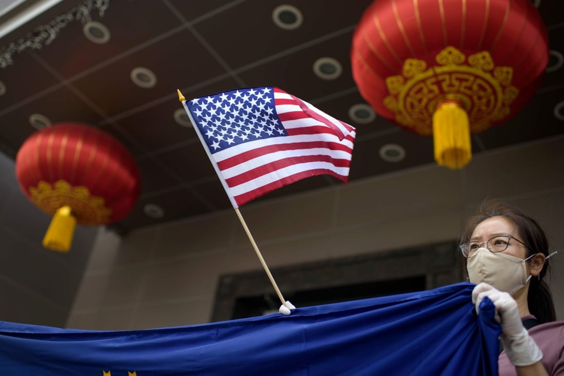 A protester holds a US flag outside the Chinese consulate in Houston on July 24, after the US State Department ordered its closure, accusing diplomats of aiding IP theft. Photo: AFP