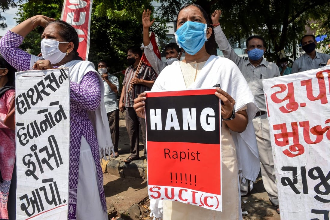 People hold placards during a protest in Ahmedabad on October 1 after the deaths of a 19-year-old and a 22-year-old woman. Photo: AFP