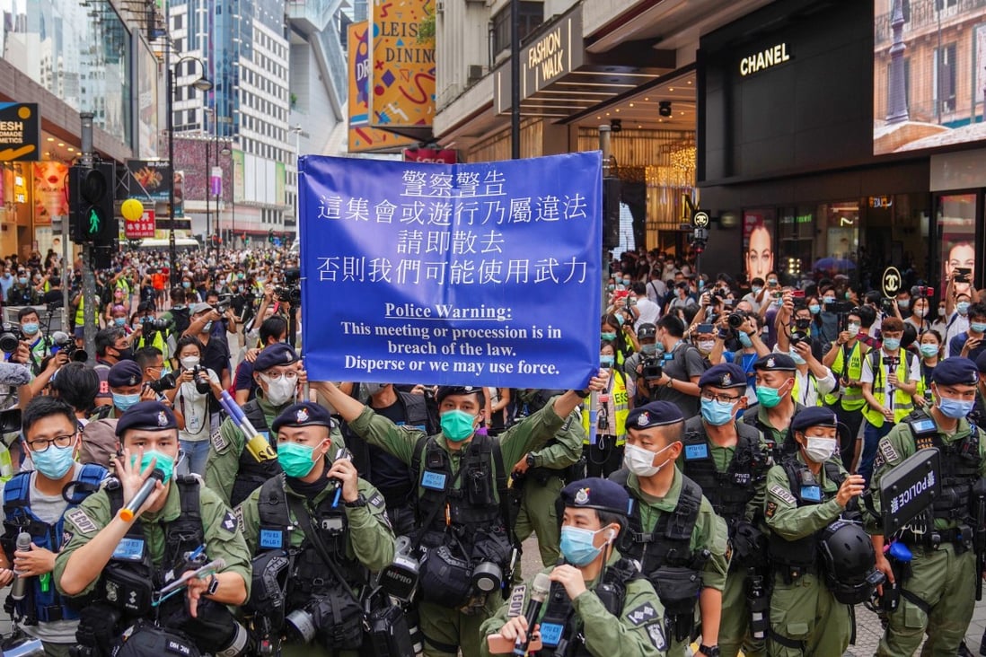 Police raise a blue warning flag on Great George Street in Causeway Bay. Photo: Sam Tsang