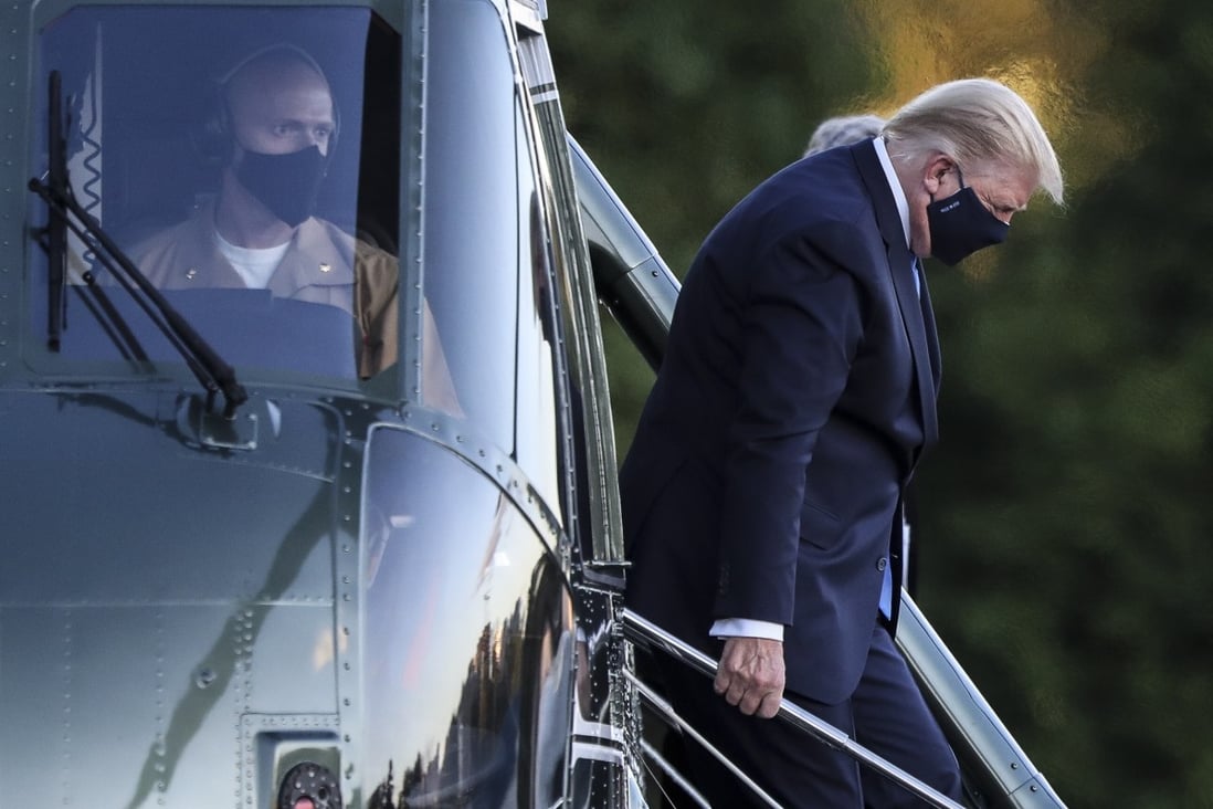 US President Donald Trump disembarks from the Marine One helicopter as he arrives at Walter Reed National Military Medical Center on Friday following his diagnosis with coronavirus. Photo: EPA