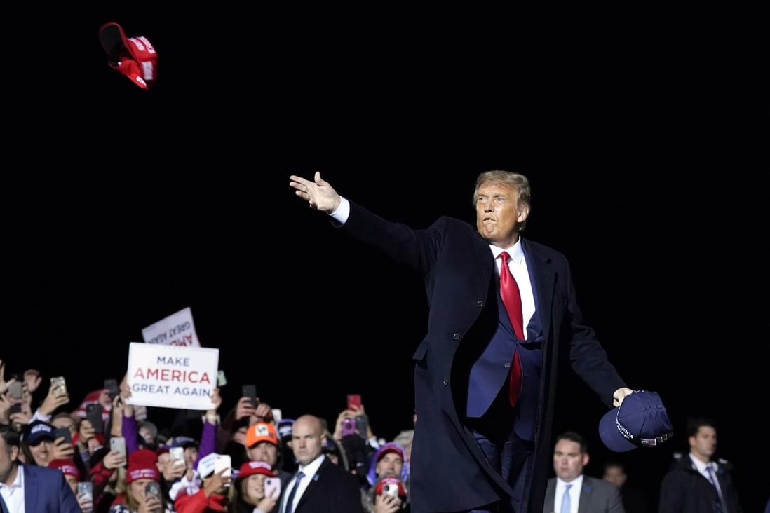 US President Donald Trump throws hats to supporters after speaking at a campaign rally at Duluth International Airport in Duluth, Minnesota on September 30. Photo: AP