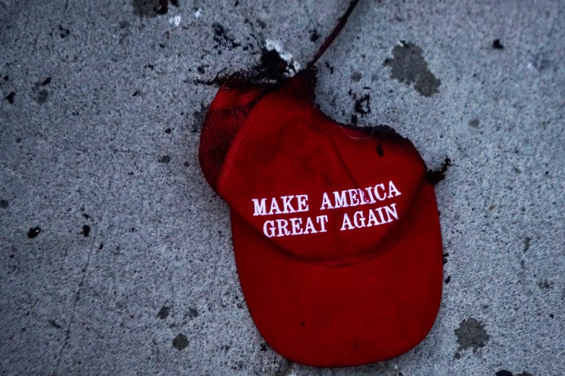 A burnt Make America Great Again cap hat lies on the ground after a protest in Tulsa, Oklahoma, in June. Photo: Reuters
